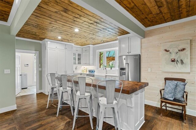 kitchen featuring white cabinetry, a breakfast bar area, and high quality fridge