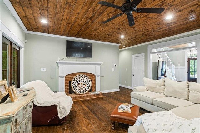 living room with crown molding, wood-type flooring, a brick fireplace, and wooden ceiling