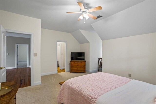 carpeted bedroom with vaulted ceiling and ceiling fan