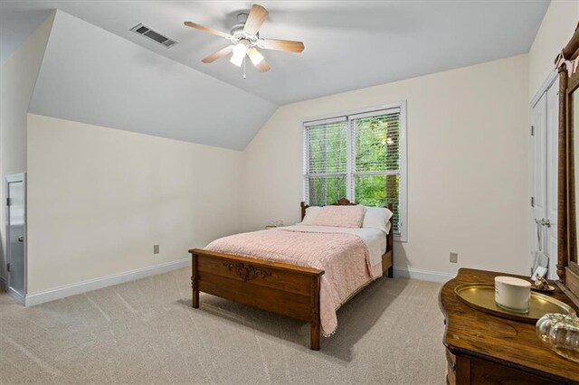 bedroom with lofted ceiling, light carpet, and ceiling fan