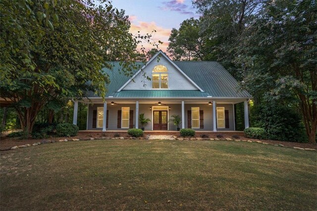 view of front of home with a yard and a porch