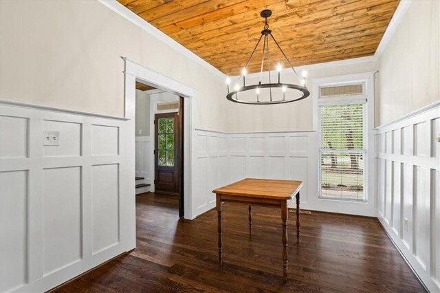 dining area with dark hardwood / wood-style flooring, ornamental molding, and wooden ceiling