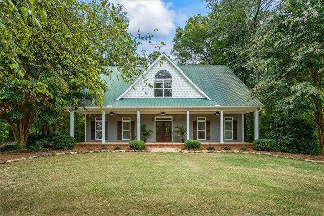 view of front of home with a front yard, french doors, and covered porch