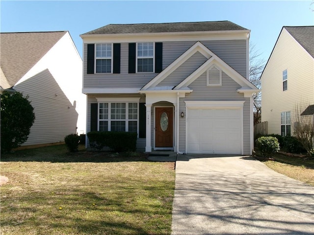 view of front of property featuring driveway, a garage, and a front yard