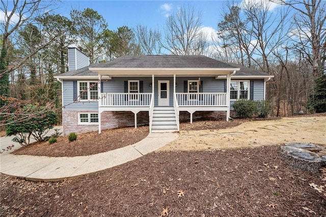 ranch-style house with covered porch and a chimney