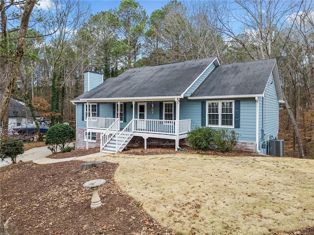 ranch-style home featuring a porch, a chimney, a shingled roof, and central air condition unit