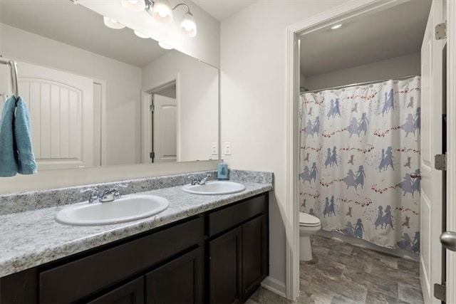 bathroom with double vanity, a shower with curtain, toilet, and a sink