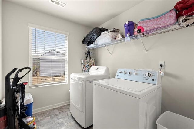 laundry area featuring laundry area, washer and clothes dryer, visible vents, and baseboards