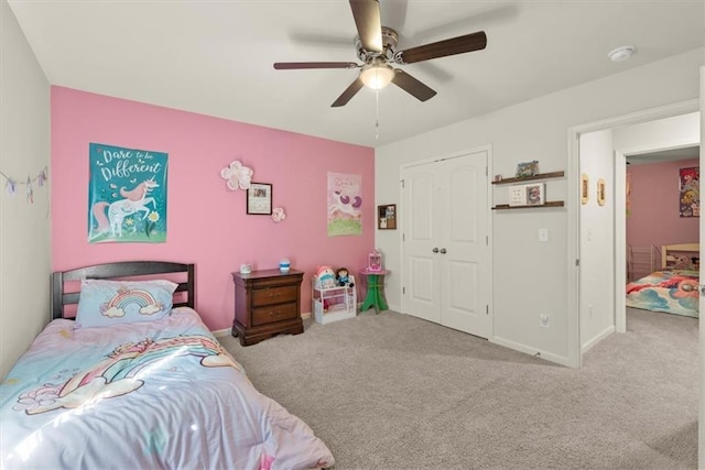 bedroom featuring ceiling fan, carpet floors, a closet, and baseboards