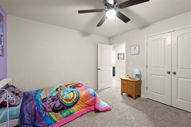 bedroom featuring ceiling fan, a closet, carpet, and baseboards