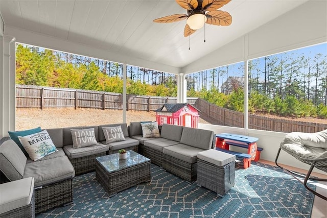 sunroom featuring vaulted ceiling and a ceiling fan