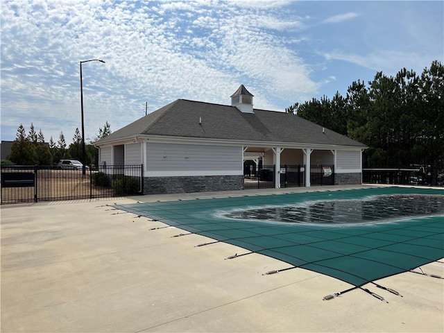 pool featuring a patio area and fence