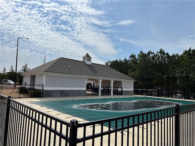 pool featuring a patio area and fence