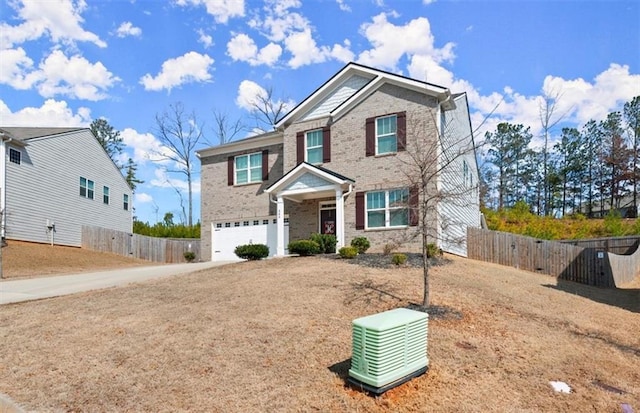 craftsman house with an attached garage, fence, concrete driveway, and brick siding