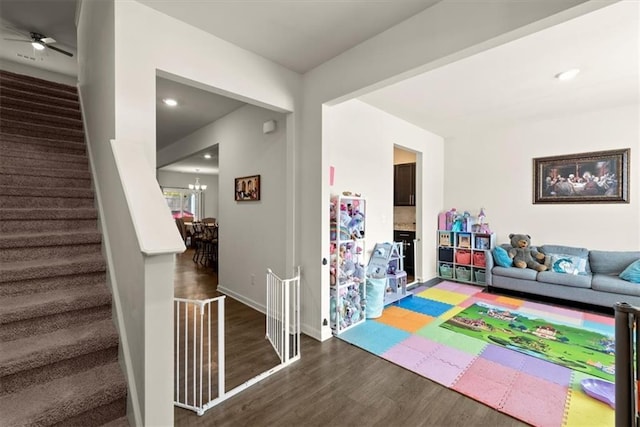 playroom featuring a chandelier, baseboards, wood finished floors, and recessed lighting