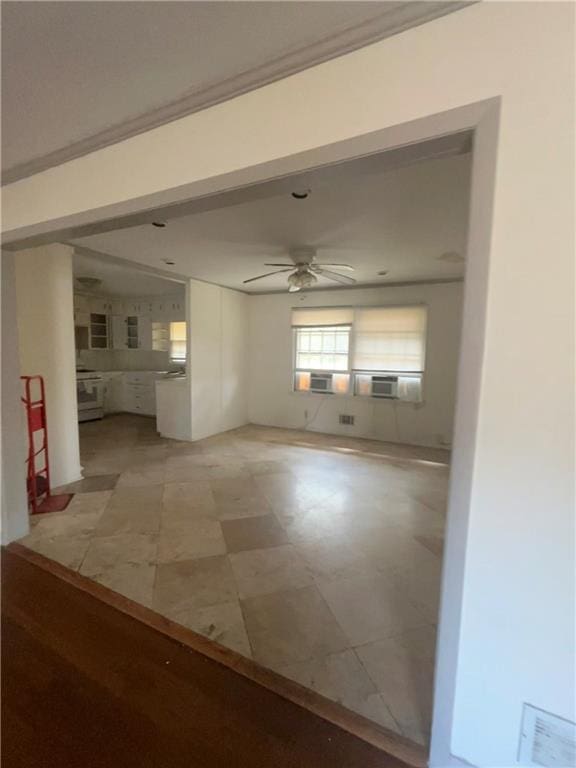 unfurnished living room featuring visible vents and ceiling fan