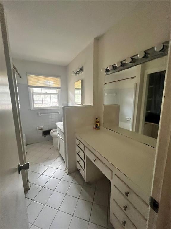 bathroom with tile patterned flooring, vanity, and toilet