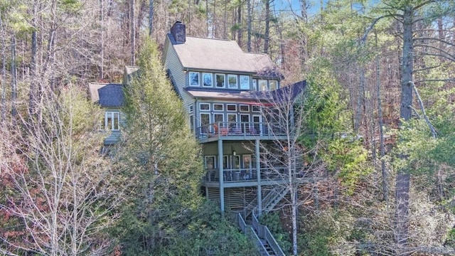 126 Jenkins Cir, Lakemont, GA 30552 - back of property with a chimney, stairs, and a wooded view