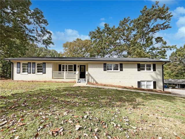 3811 Reynolds Rd, Douglasville, GA 30135 - ranch-style home with a front yard, a porch, and brick siding