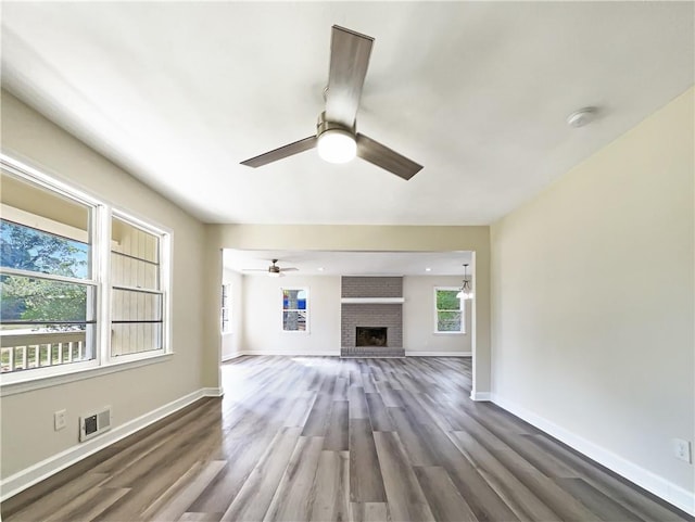 3811 Reynolds Rd, Douglasville, GA 30135 - unfurnished living room featuring ceiling fan, baseboards, visible vents, and wood finished floors