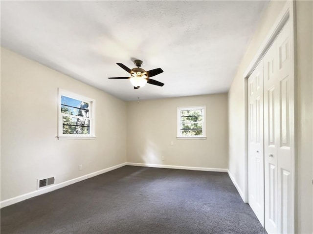 3811 Reynolds Rd, Douglasville, GA 30135 - unfurnished bedroom with baseboards, dark carpet, a closet, and visible vents