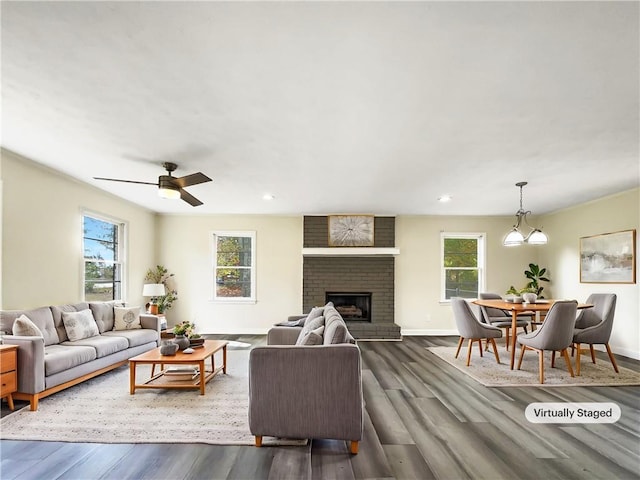 living room with a fireplace, dark hardwood / wood-style floors, plenty of natural light, and ceiling fan