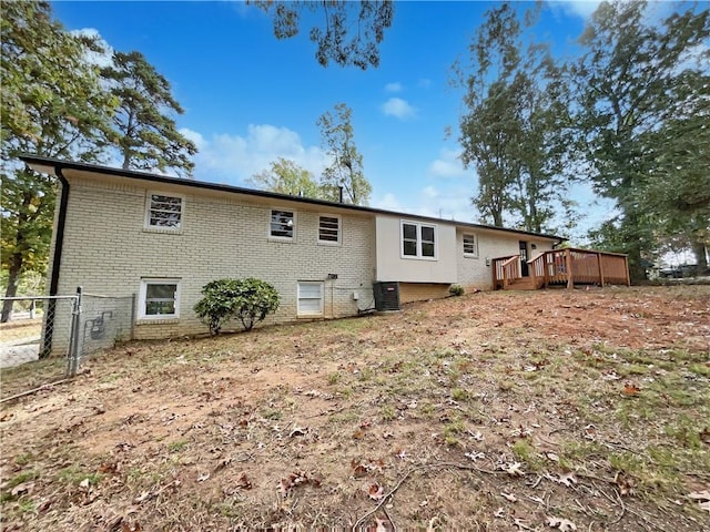 3811 Reynolds Rd, Douglasville, GA 30135 - back of house with fence, a deck, brick siding, and central AC