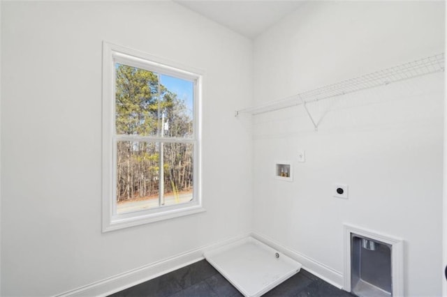 clothes washing area featuring hookup for an electric dryer, laundry area, baseboards, and hookup for a washing machine