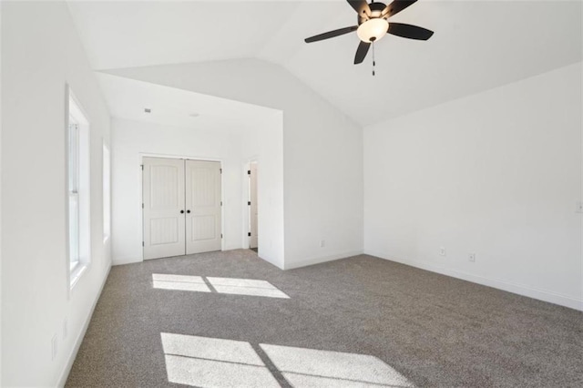 interior space with carpet flooring, a ceiling fan, baseboards, vaulted ceiling, and a closet