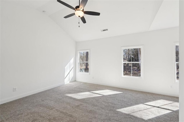 carpeted spare room with baseboards, ceiling fan, high vaulted ceiling, and visible vents