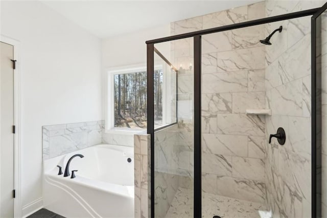 bathroom featuring a shower stall and a garden tub