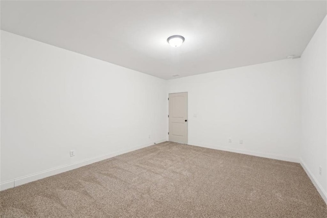 carpeted empty room with baseboards