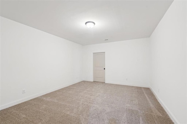 empty room with baseboards and light colored carpet