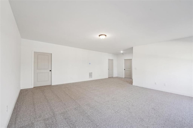 unfurnished room featuring light colored carpet