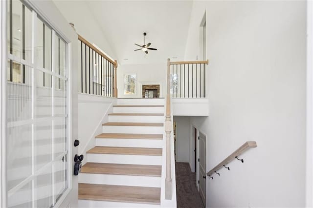 stairway featuring high vaulted ceiling, ceiling fan, and french doors