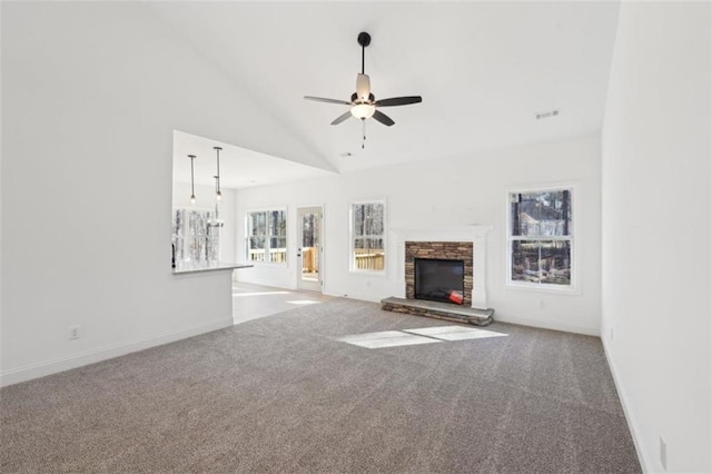unfurnished living room featuring ceiling fan, baseboards, carpet, and a fireplace