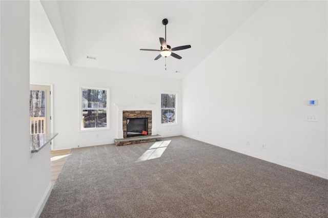 unfurnished living room featuring a ceiling fan, a fireplace, carpet floors, baseboards, and high vaulted ceiling