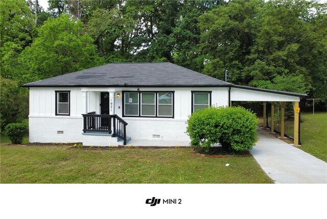 1931 Selwyn Dr, Decatur, GA 30035 - view of front facade with concrete driveway, a front lawn, roof with shingles, and brick siding