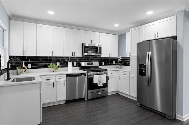 1931 Selwyn Dr, Decatur, GA 30035 - kitchen with appliances with stainless steel finishes, a sink, white cabinets, tasteful backsplash, and light countertops