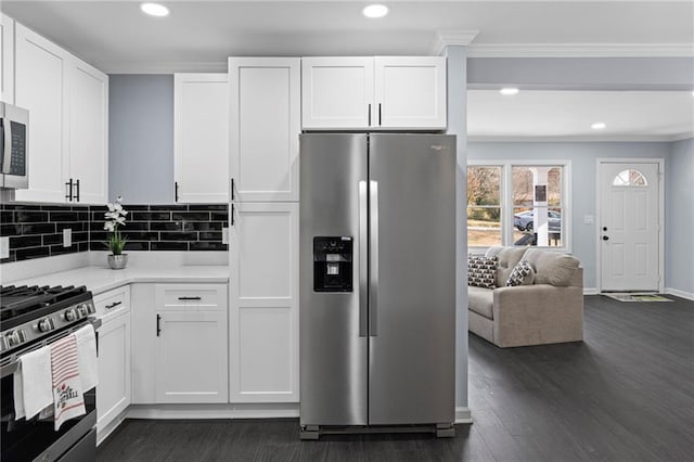 1931 Selwyn Dr, Decatur, GA 30035 - kitchen featuring stainless steel appliances, ornamental molding, light countertops, white cabinetry, and dark wood-style flooring