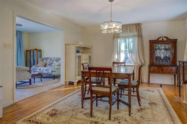 dining room featuring light hardwood / wood-style flooring and an inviting chandelier