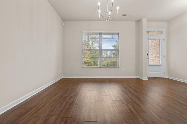 unfurnished dining area featuring dark hardwood / wood-style flooring and a chandelier