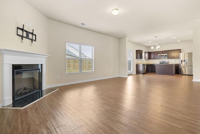 unfurnished living room with hardwood / wood-style flooring