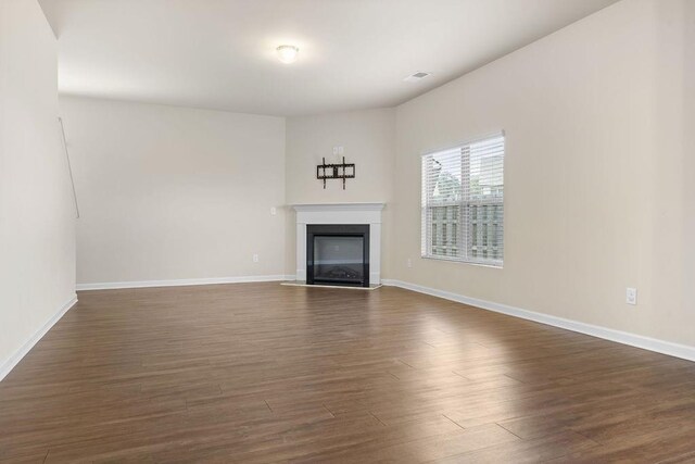 unfurnished living room featuring dark hardwood / wood-style floors