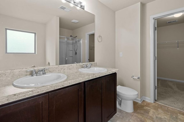 bathroom featuring toilet, an enclosed shower, and vanity