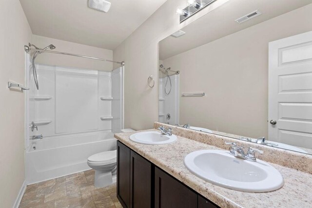 full bathroom with vanity, tub / shower combination, and toilet