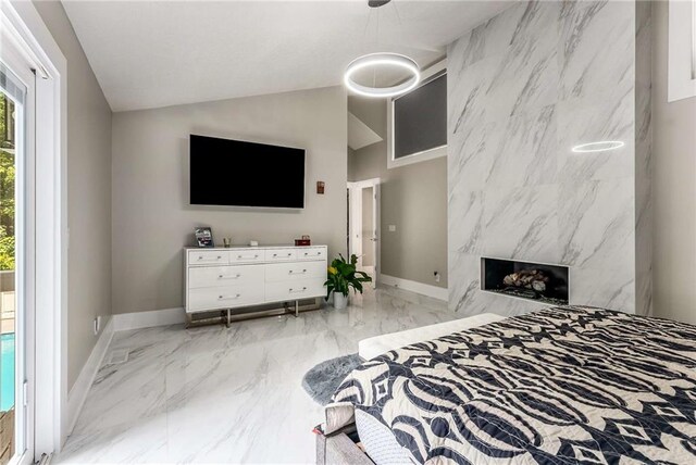 tiled bedroom with a high end fireplace, tile walls, lofted ceiling, and access to outside