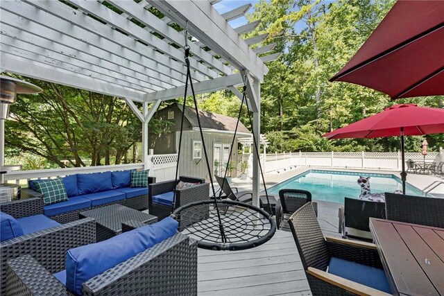 view of pool featuring a pergola, an outdoor hangout area, and a deck