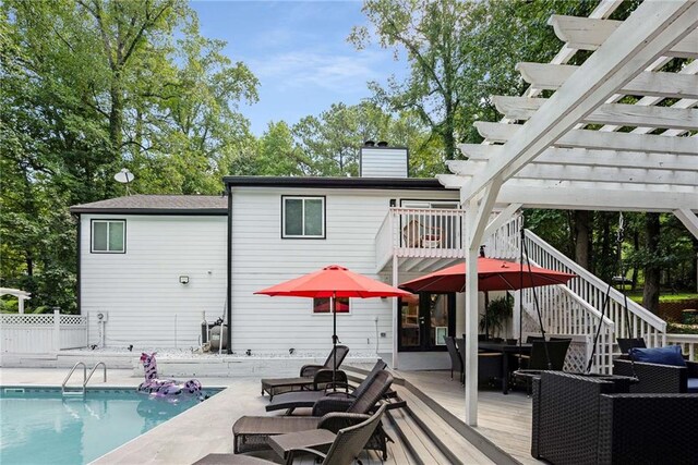 deck featuring a fenced in pool, an outdoor hangout area, and a pergola