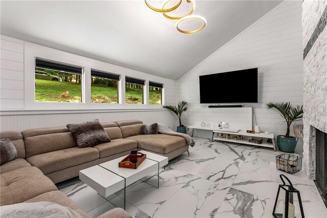 tiled living room featuring high vaulted ceiling, a fireplace, and wooden walls